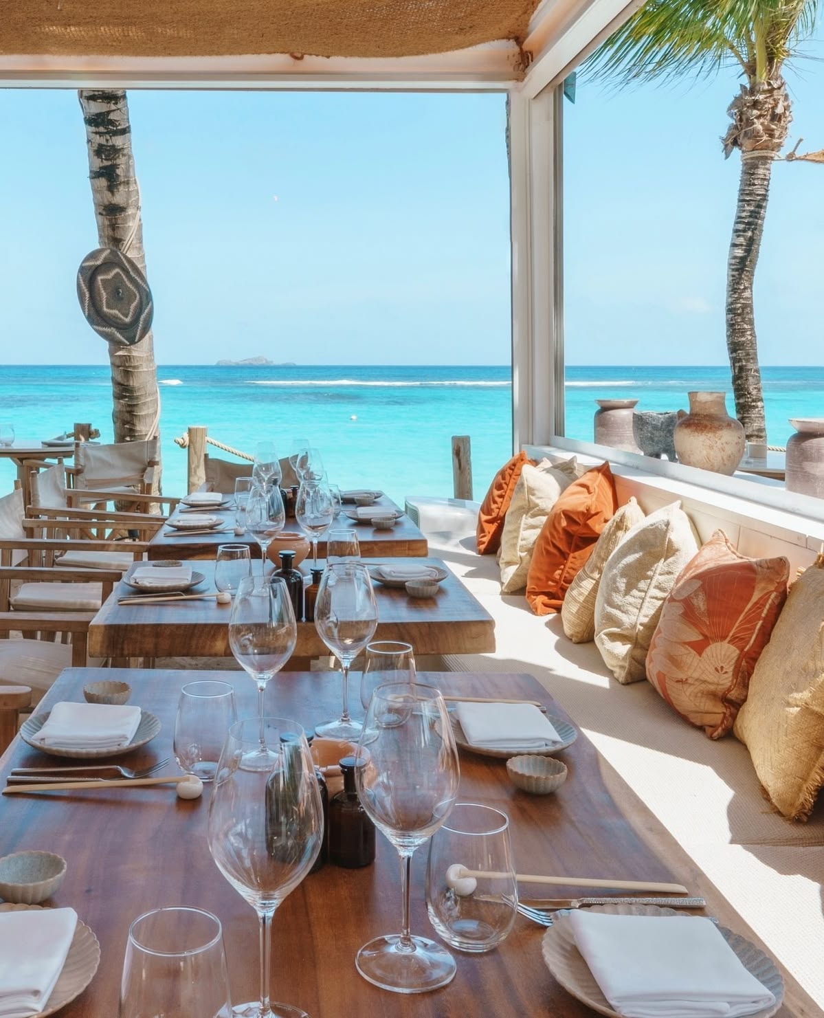 Tables laid for dinner looking out over turquoise water in the Turks and Caicos